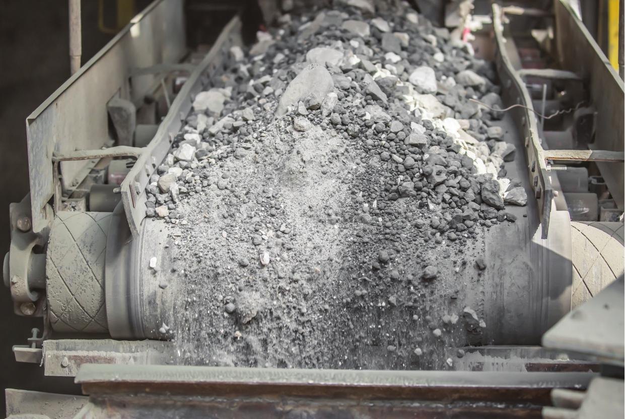 Clinker travelling along a conveyor belt at a cement plant