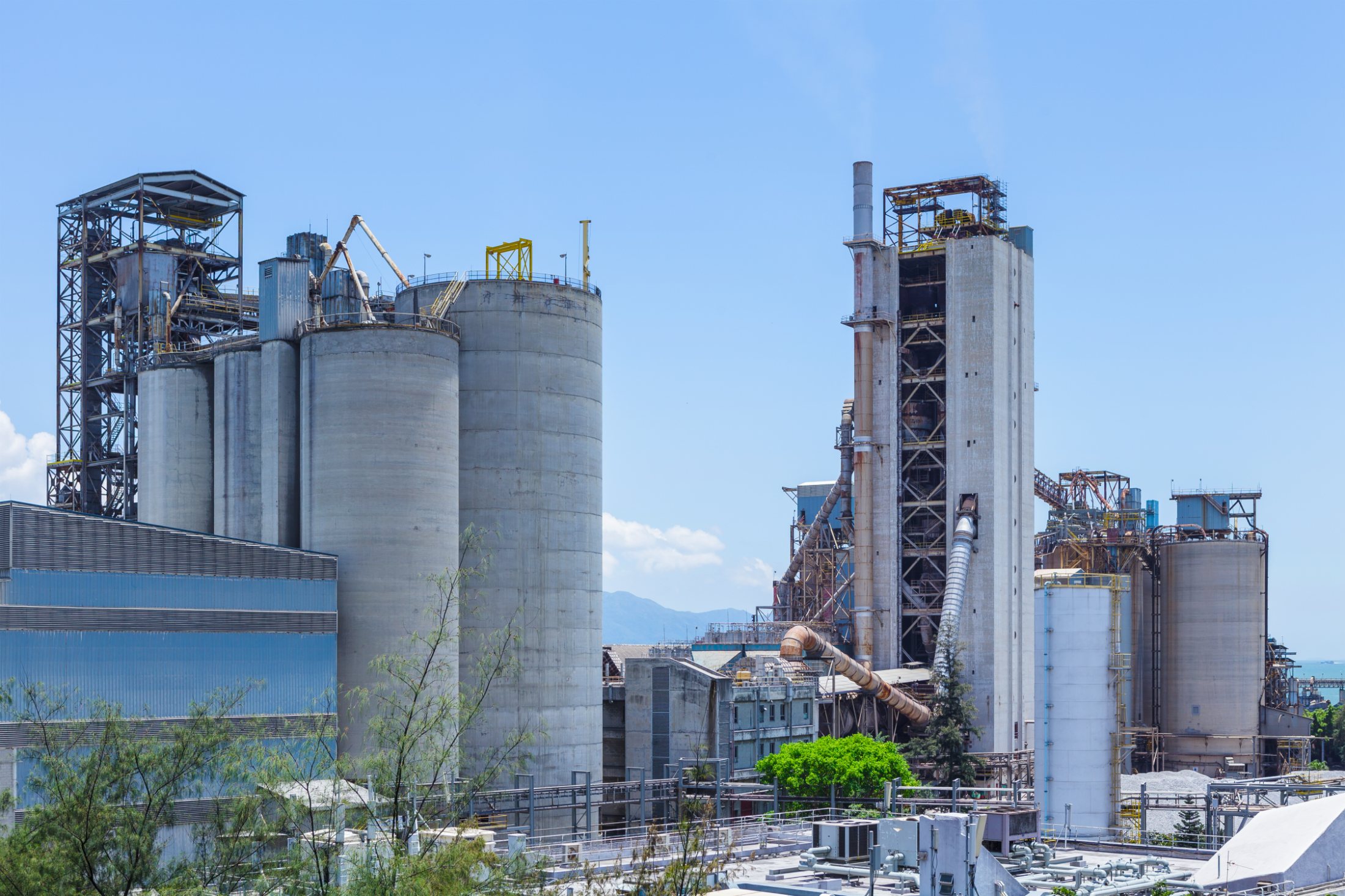 Cement plant silos under a bright sky